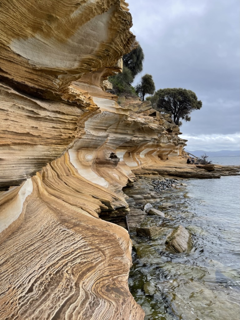 Layered sedimentary rock formations along coastline