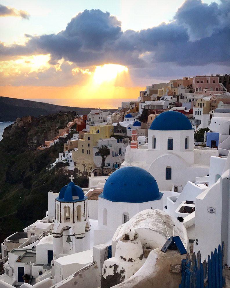 Santorini sunset with white buildings and blue domes