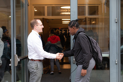 Thomas O'Brien greeting a student at school entrance